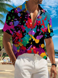 New Men's Casual Short-Sleeve Shirt with Vibrant Ink Splatter Print on Black Background, Bold Contrasting Colors for Festive Parties, Commuting, and Versatile Casual Wear. Made of Polyester Fiber, Machine Washable. Button-Up Printed Shirt